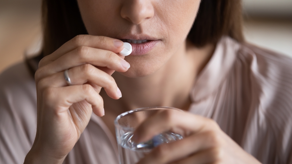 Close,Up,Sick,Woman,Holds,Glass,Of,Water,Takes,Pill couples counseling